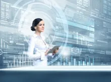 AI-powered video creation: A businesswoman in front of a futuristic interface with data charts, representing artificial intelligence's role in enhancing video production.